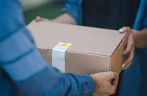 man giveing parcel to woman