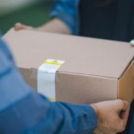 man giveing parcel to woman