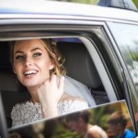 Bride sitting in a limo